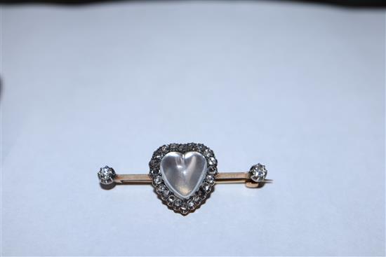 A diamond and moonstone bar brooch, heart-shaped setting in yellow metal (one stone missing), boxed 40mm.